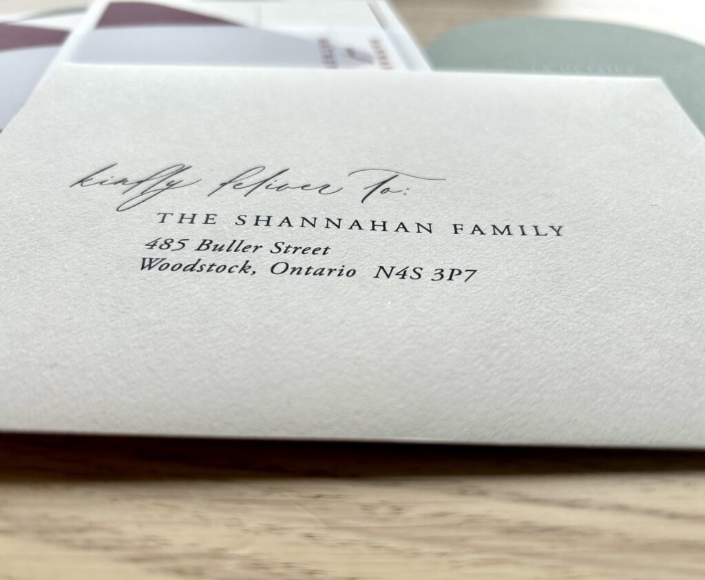 Wedding invitation addressing "The Shannahan Family" in black ink on cream envelope