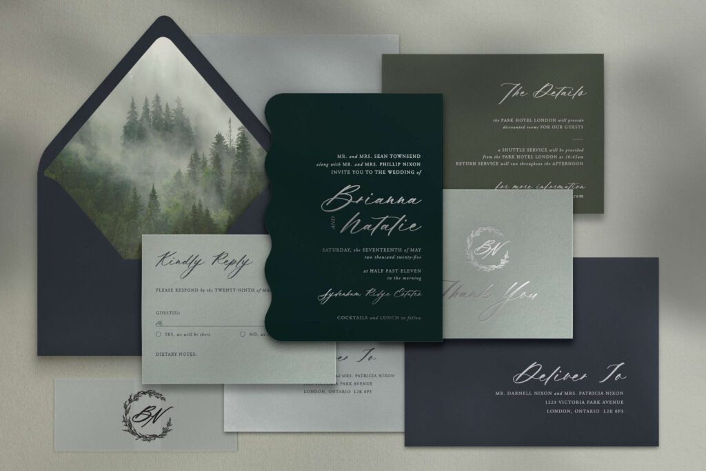 Moody green and blue custom wedding invitation with silver foil and with a forest-theme and custom monogram
